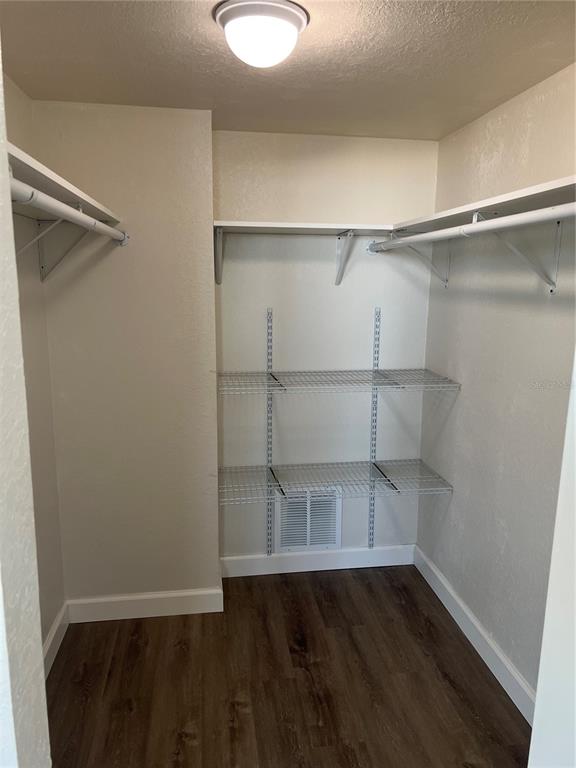 A walk-in closet features wood-look flooring, white walls, wire shelving, and a ceiling light — 5701 BAHIA DEL MAR CIRCLE UNIT 508, ST PETERSBURG, FL