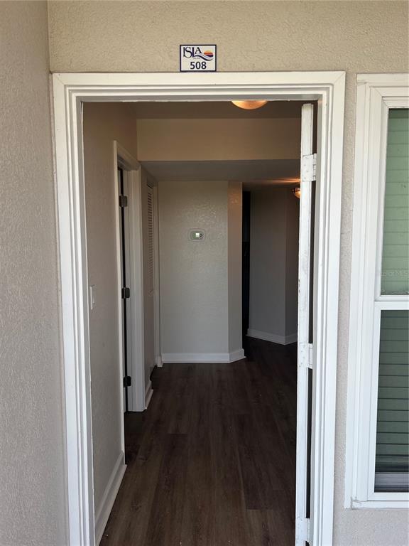 The view shows the entryway of a residential unit with dark wood-look flooring — 5701 BAHIA DEL MAR CIRCLE UNIT 508, ST PETERSBURG, FL