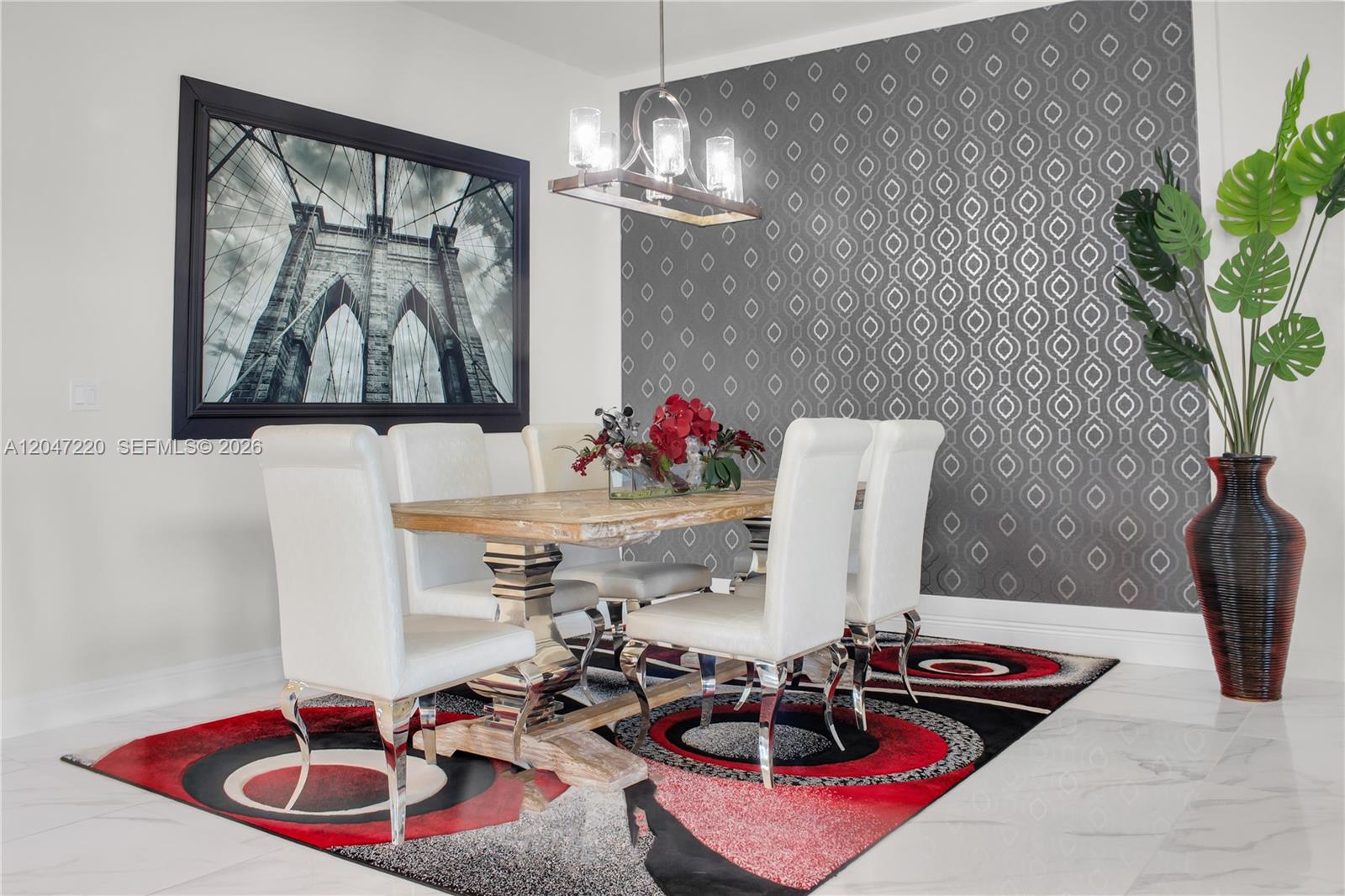 A dining room features a wooden table, white chairs, a patterned accent wall, and rug — 15750 Longboat Key Dr, Westlake FL 33470, WESTLAKE, FL