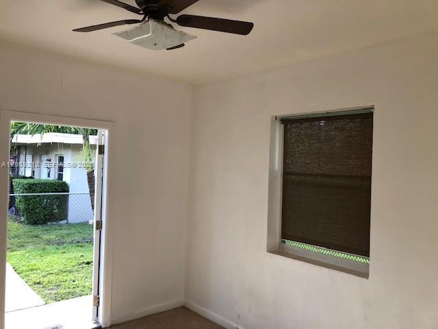A room with white walls, a ceiling fan, and a door opening to a yard — 471 SW 10th St # 5, Miami FL 33130, MIAMI, FL