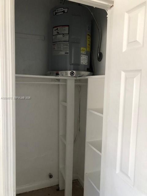 A closet contains a water heater mounted on a shelf above built-in storage shelving — 471 SW 10th St # 5, Miami FL 33130, MIAMI, FL