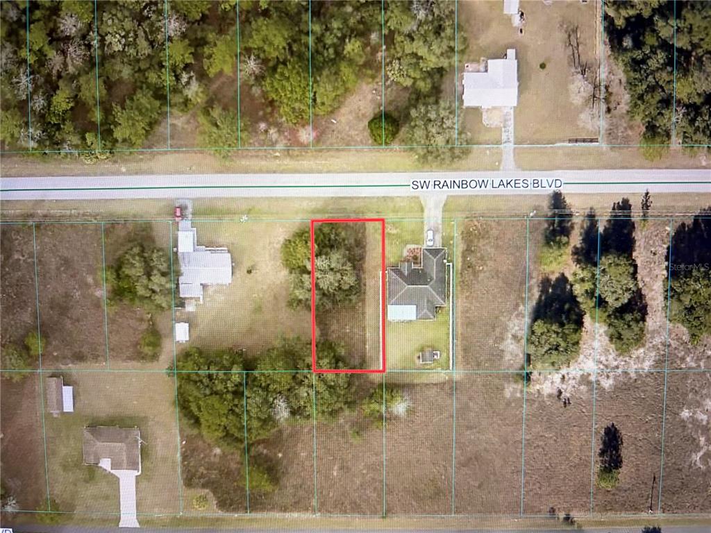 This aerial map shows a vacant rectangular lot outlined in red along a paved road — TBD SW RAINBOW LAKES BOULEVARD, DUNNELLON, FL
