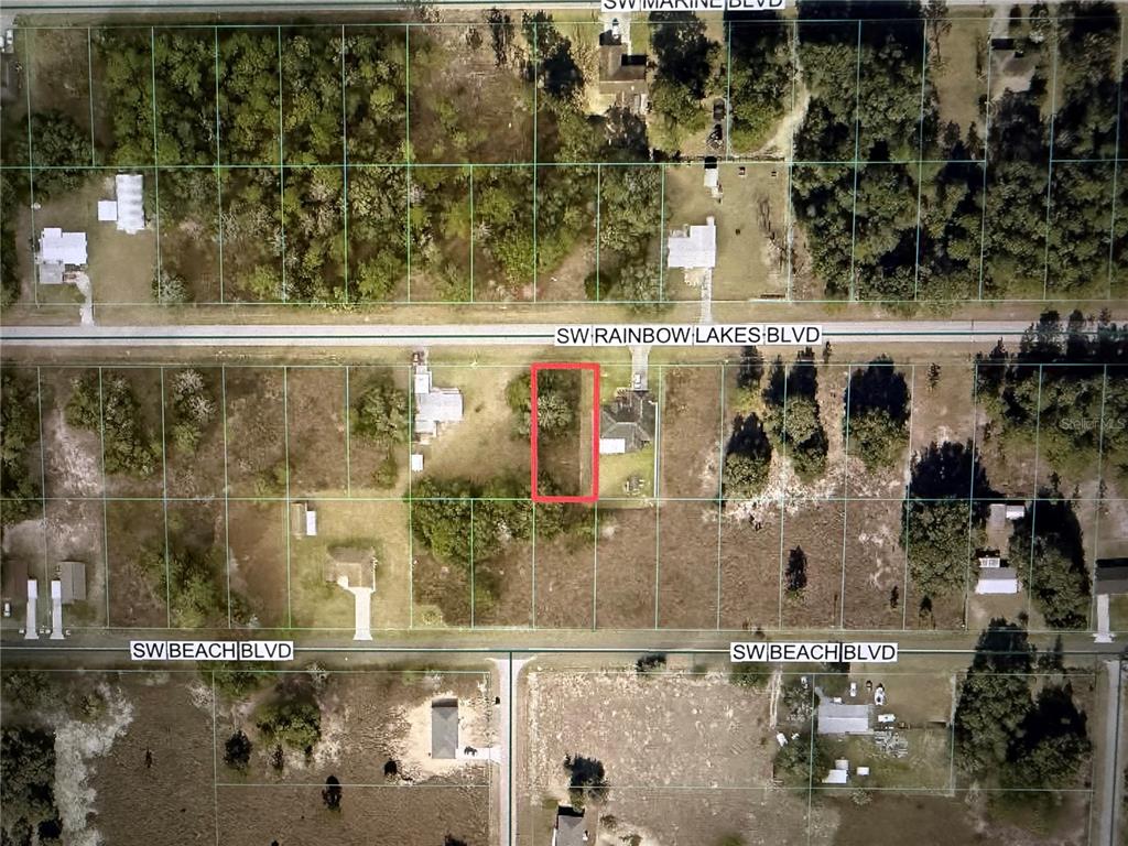 This aerial map shows a rectangular lot outlined in red between two residential streets — TBD SW RAINBOW LAKES BOULEVARD, DUNNELLON, FL