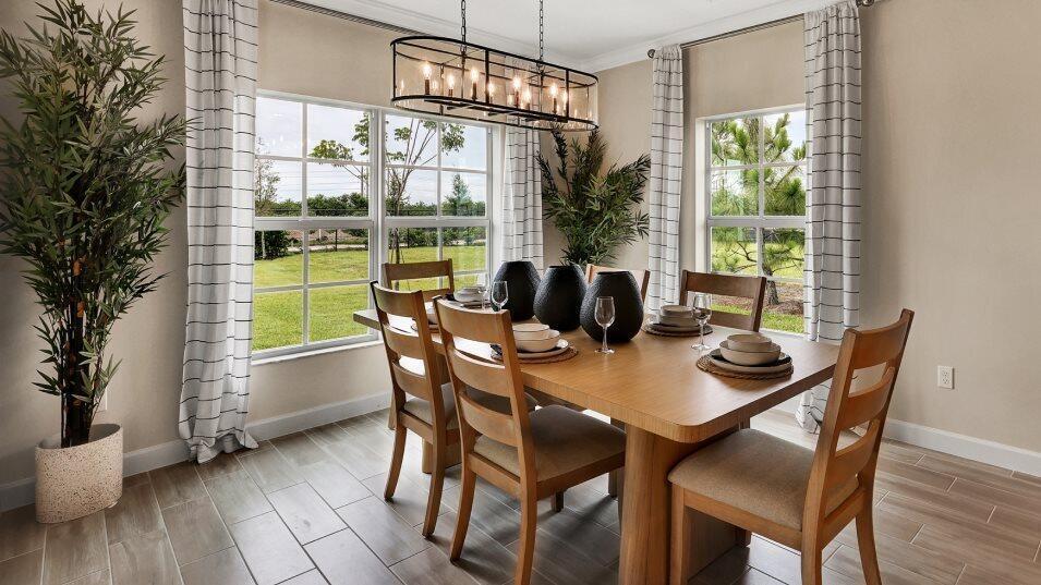 A dining room features a wooden table, six chairs, a rectangular chandelier, and large windows — 19868 Whispering Creek Road, FL 33470, FL