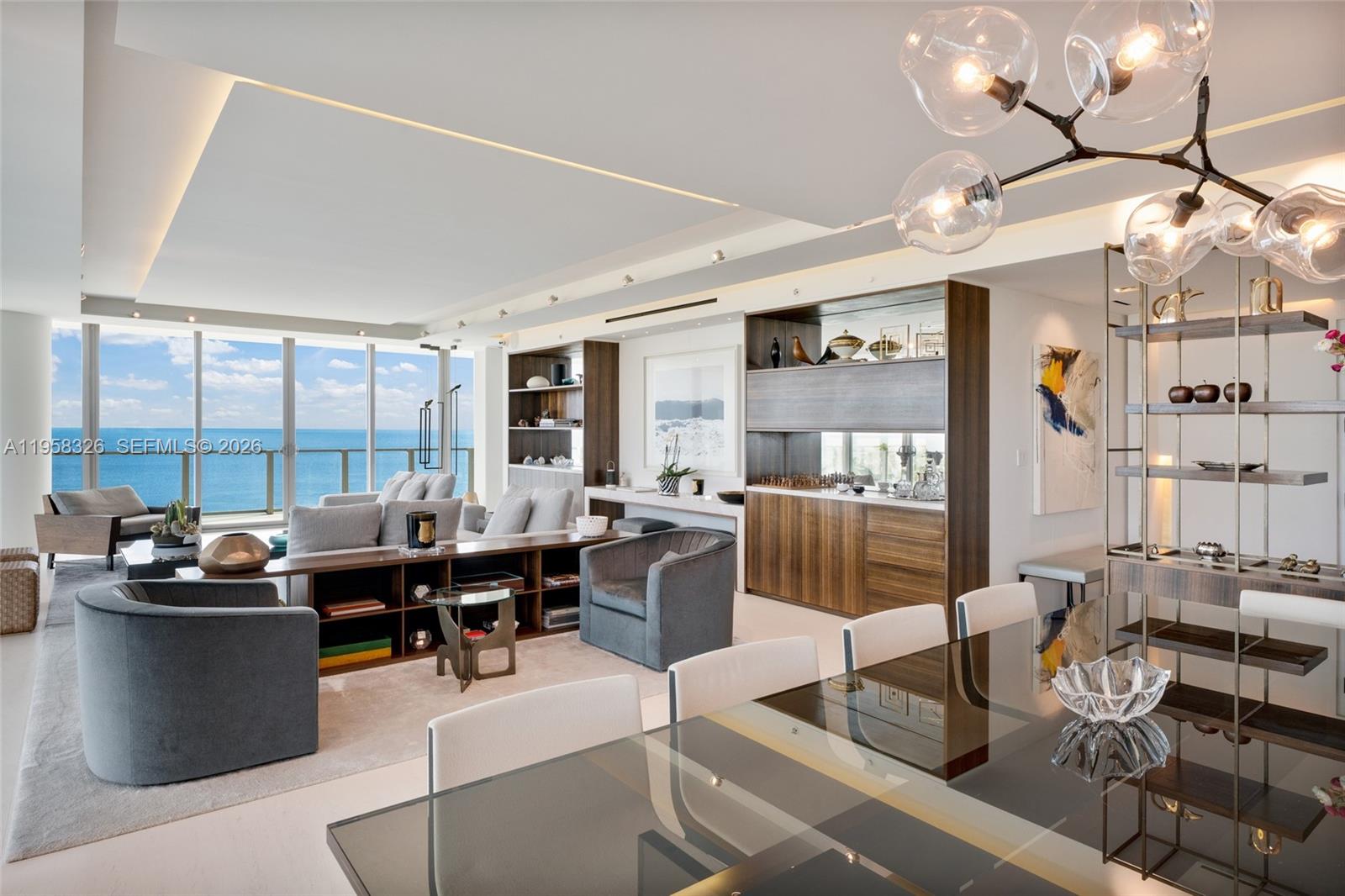 A modern living and dining area features floor-to-ceiling windows overlooking the ocean — 350 Ocean Dr # 701N, Key Biscayne FL 33149, KEY BISCAYNE, FL