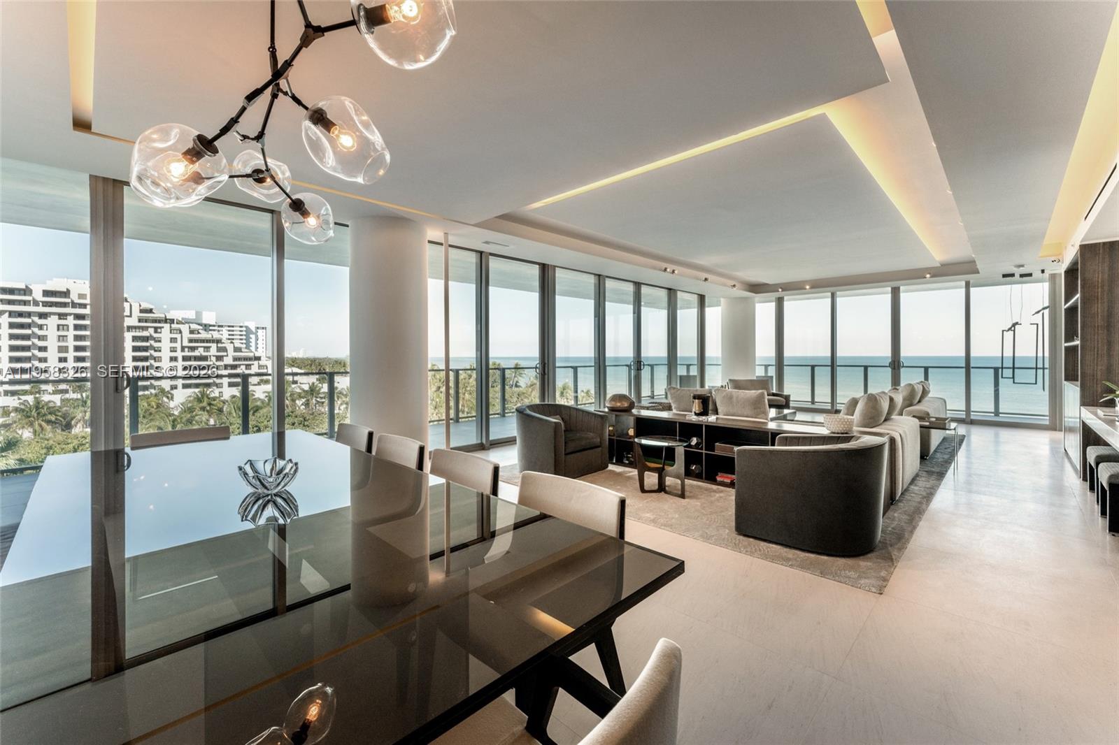 A modern open-concept living and dining area features floor-to-ceiling windows with ocean views — 350 Ocean Dr # 701N, Key Biscayne FL 33149, KEY BISCAYNE, FL
