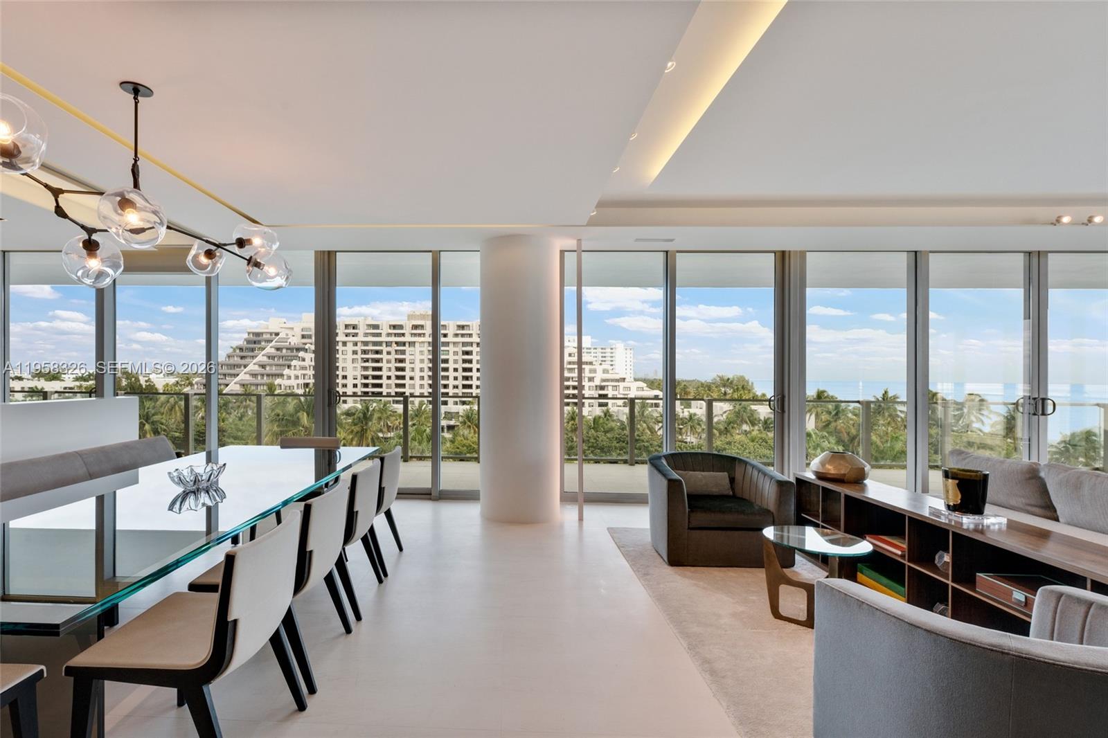 A modern dining and living area features floor-to-ceiling windows with views of nearby buildings — 350 Ocean Dr # 701N, Key Biscayne FL 33149, KEY BISCAYNE, FL