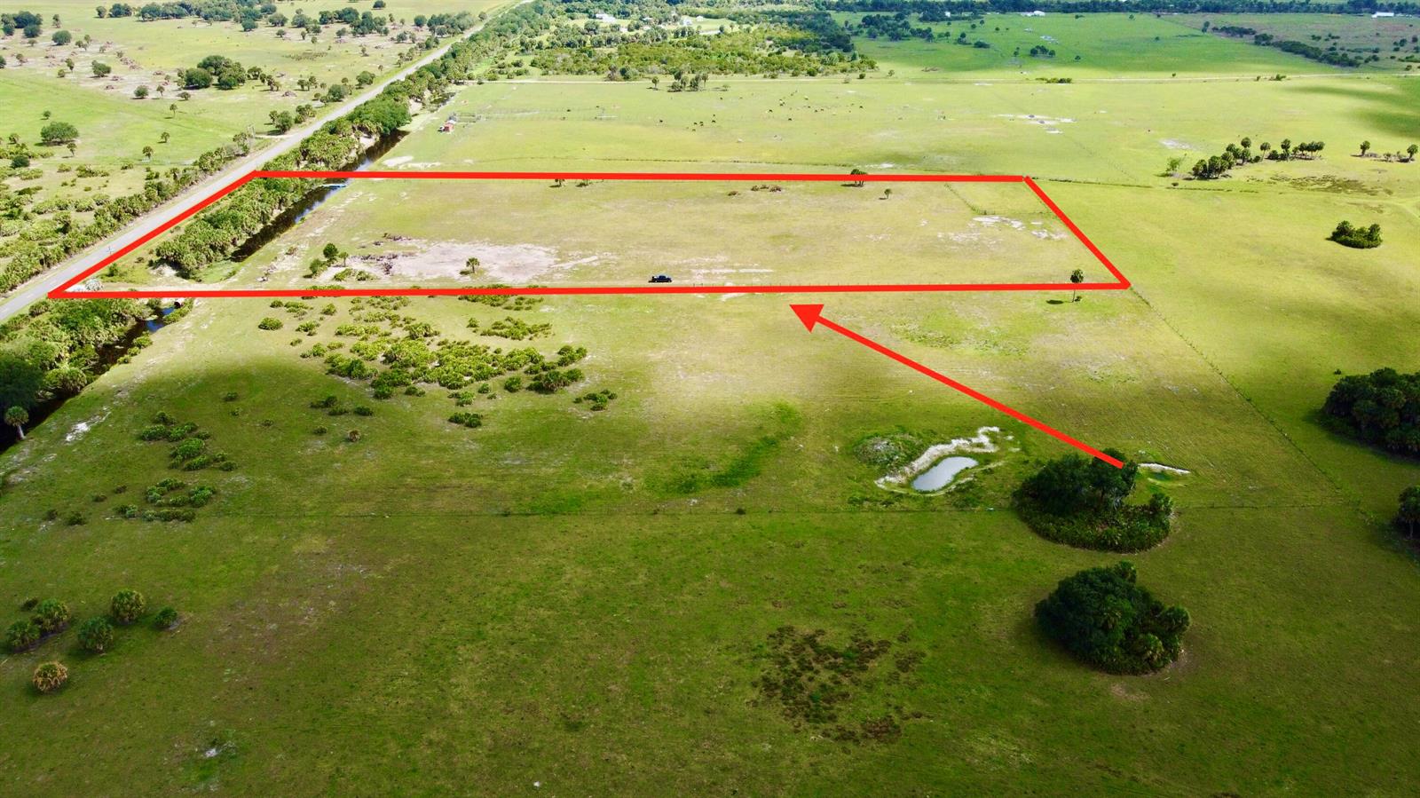 An aerial view shows a rectangular plot of land outlined in red in a field — 28095 NW 72nd Avenue, Okeechobee FL 34972, OKEECHOBEE, FL
