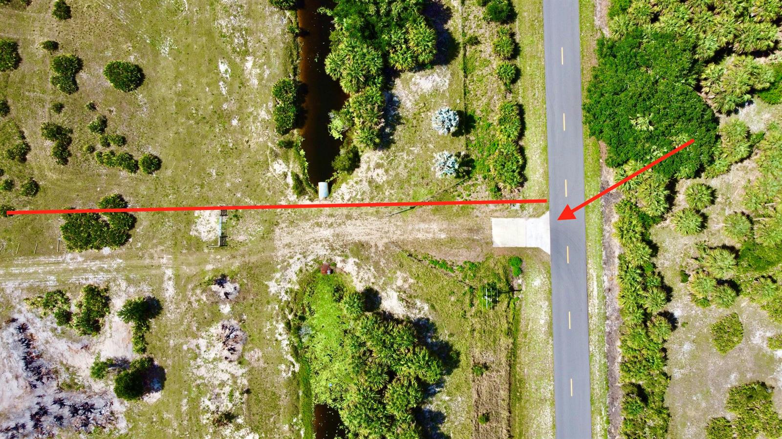 Aerial view of a rural road with a concrete driveway entrance and a red line — 28095 NW 72nd Avenue, Okeechobee FL 34972, OKEECHOBEE, FL