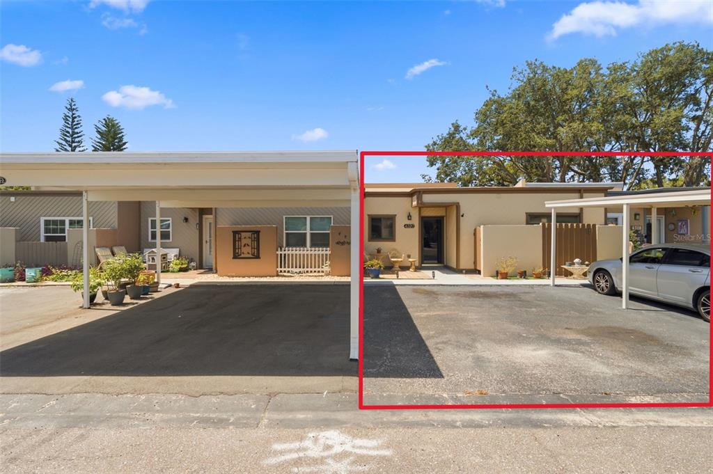 Exterior view of two adjacent single-story residential units with attached carports and paved driveways — 4320 FERN GLEN ST, HOLIDAY, FL