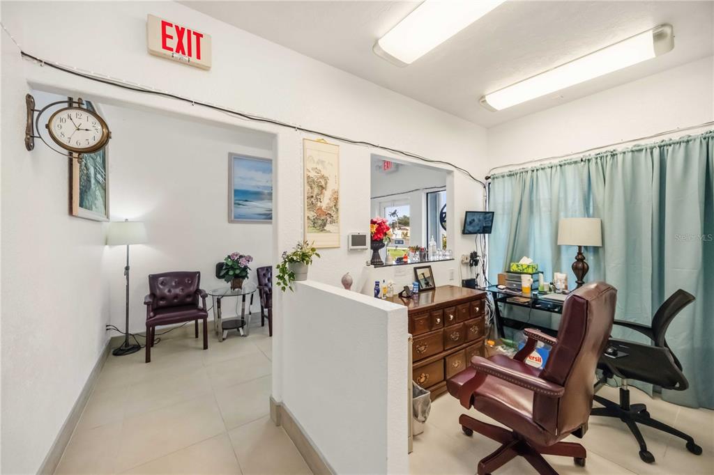 An office space features a reception area, a wooden desk, and a waiting room — 2081 TAMIAMI TRAIL, PORT CHARLOTTE, FL