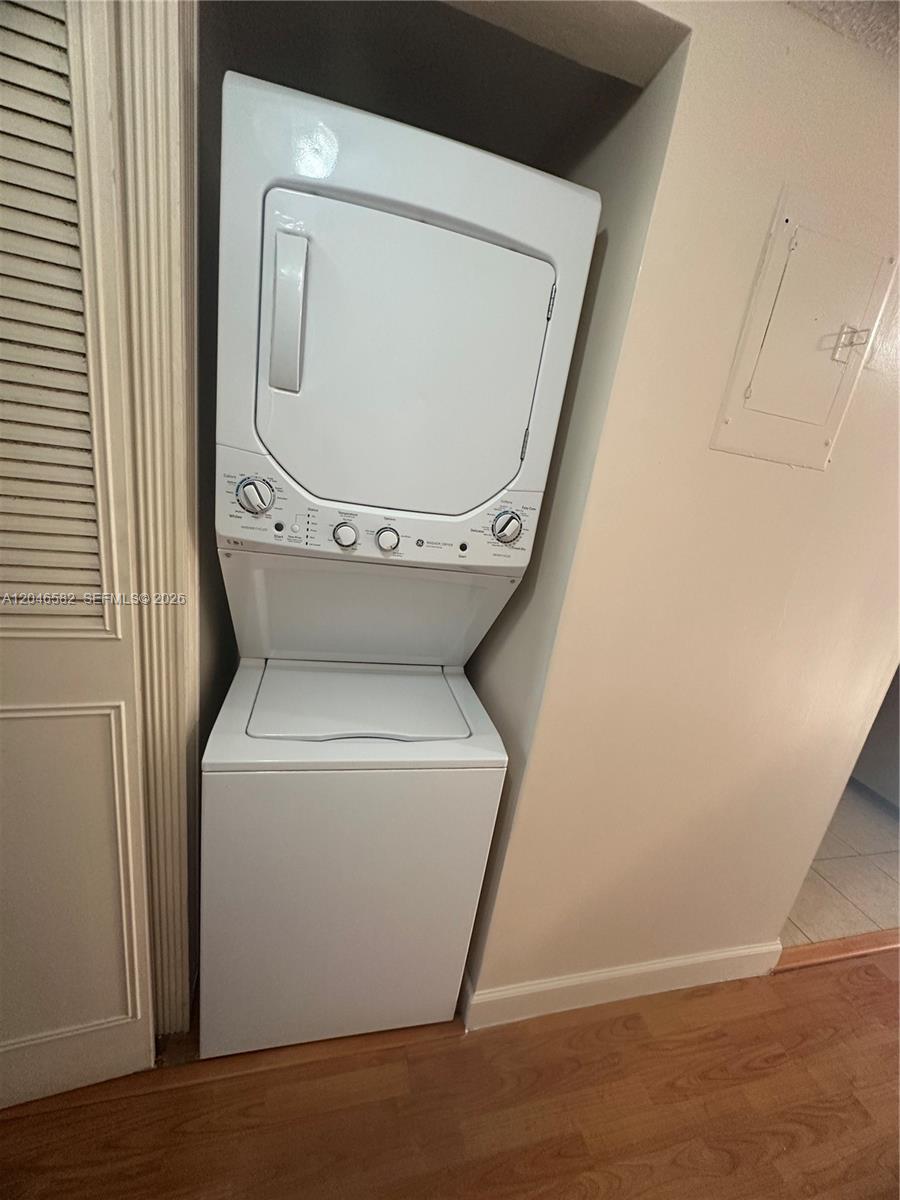 A white stacked washer and dryer unit is installed in a small wall alcove — 9500 SW 3rd St # 254, Boca Raton FL 33428, BOCA RATON, FL