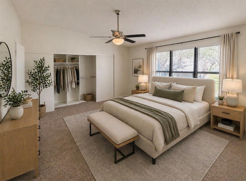 A bedroom features a queen bed, a sliding-door closet, a ceiling fan, and neutral decor — 819 OAK PARK PLACE, BRANDON, FL
