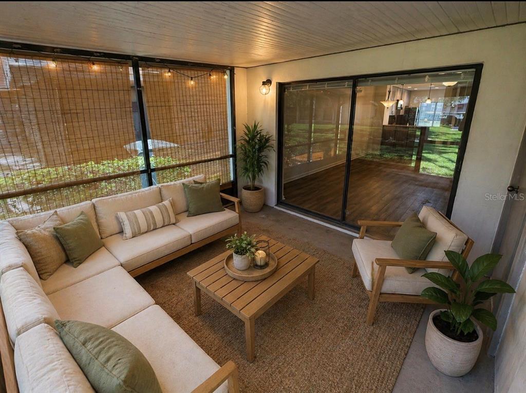 A furnished screened-in patio features a sectional sofa, armchair, coffee table, and sliding glass doors — 819 OAK PARK PLACE, BRANDON, FL
