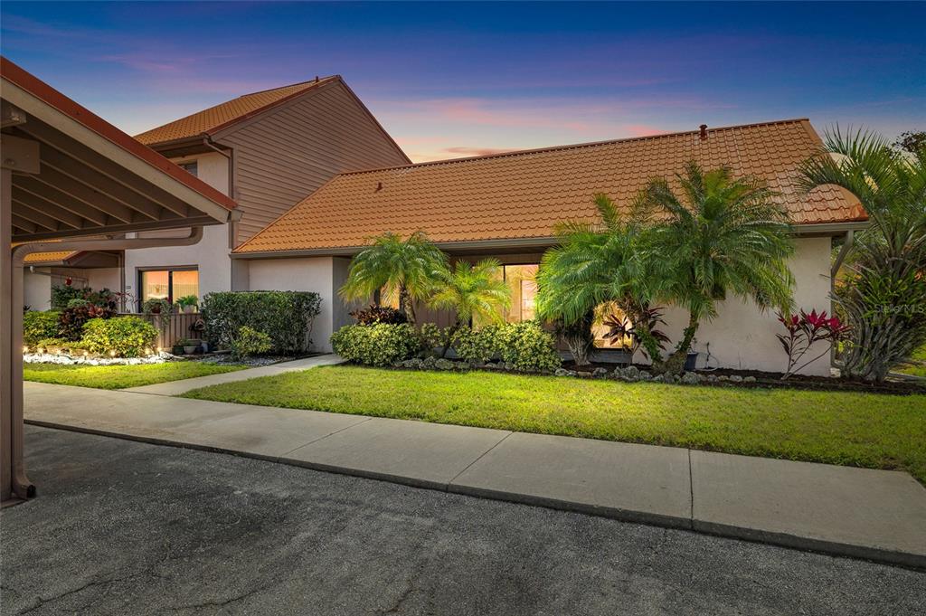 An aerial view shows a residential complex with red-roofed buildings surrounded by several ponds — 6535 DRAW LANE UNIT 85, SARASOTA, FL