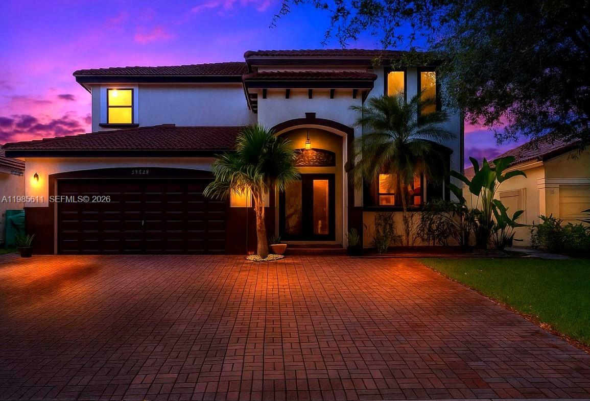 A two-story house with a brown garage, tiled roof, and a paved driveway — 22542 SW 103rd Ct, Cutler Bay FL 33190, CUTLER BAY, FL