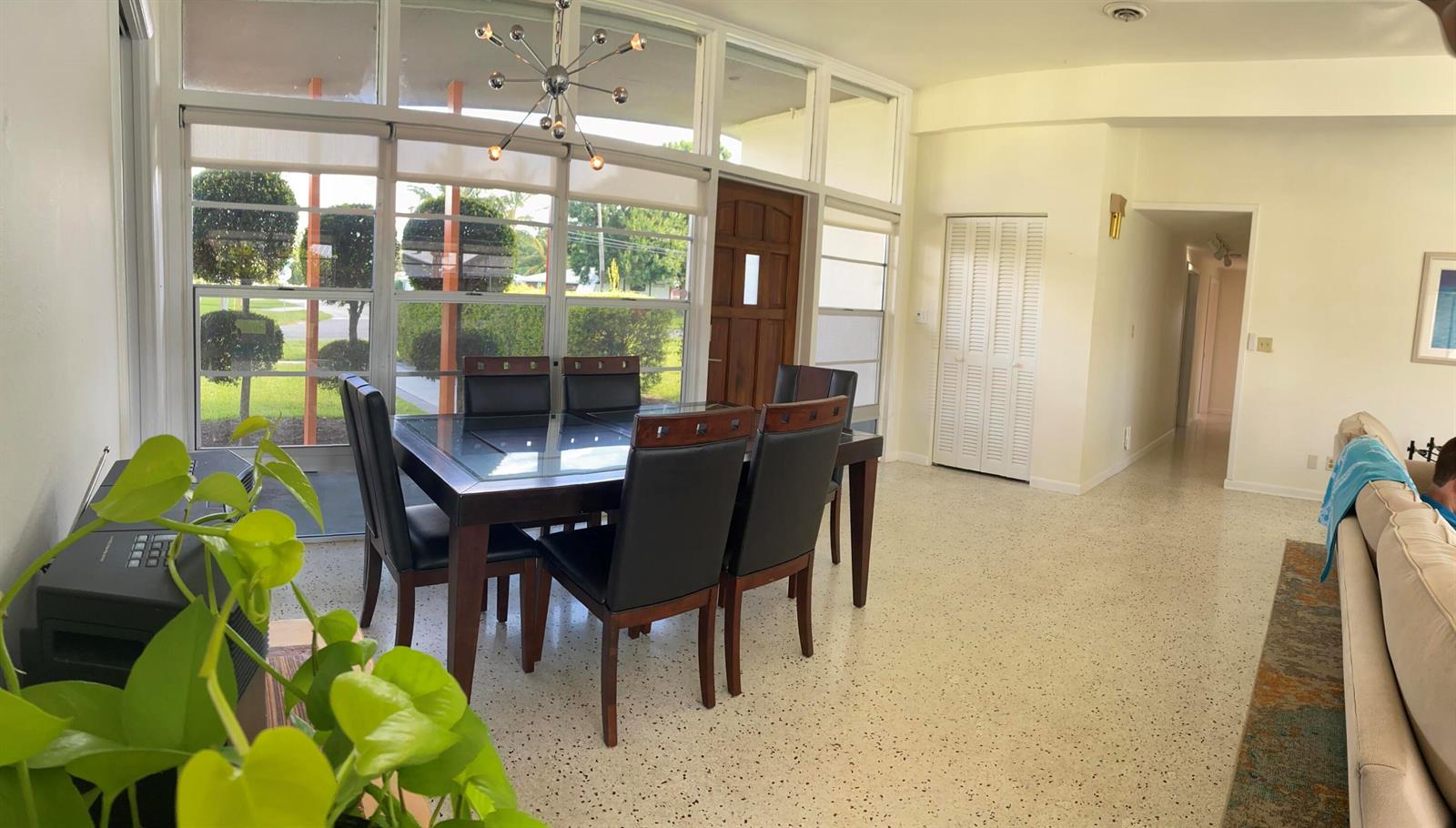 A grassy backyard features a swimming pool, lounge chairs, an umbrella, and a wooden fence — 403 21st Place SE, Vero Beach FL 32962, VERO BEACH, FL