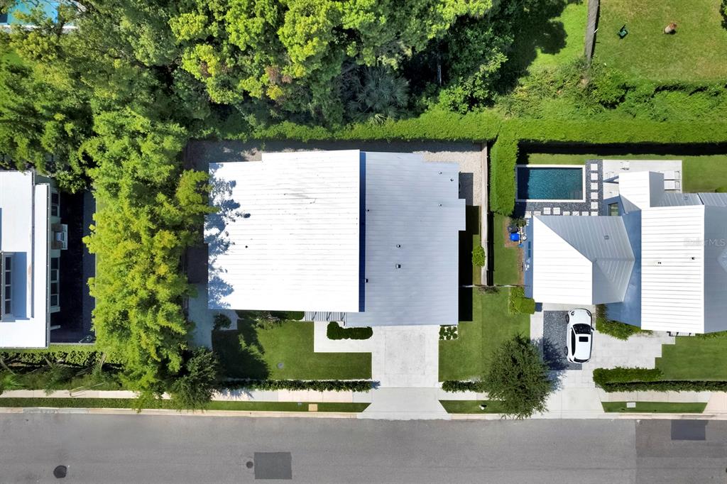 An aerial view shows two modern houses with white roofs, a pool, and landscaped yards — 462 W LYMAN AVENUE, WINTER PARK, FL