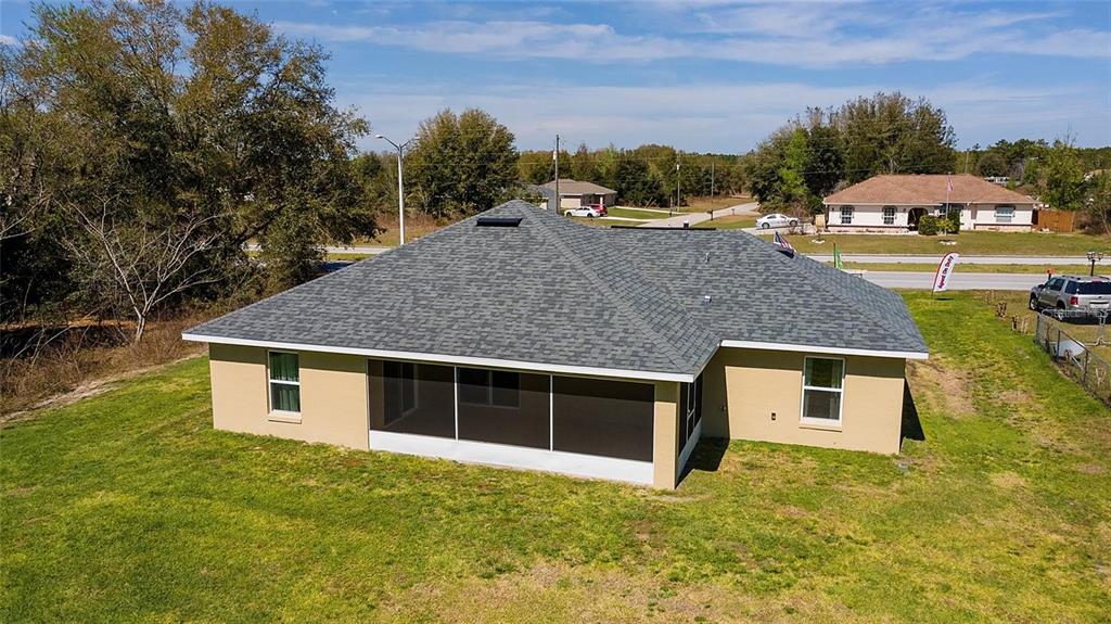 An aerial view of the back of a tan house with a screened-in porch — 4887 SW 159TH LANE ROAD, OCALA, FL