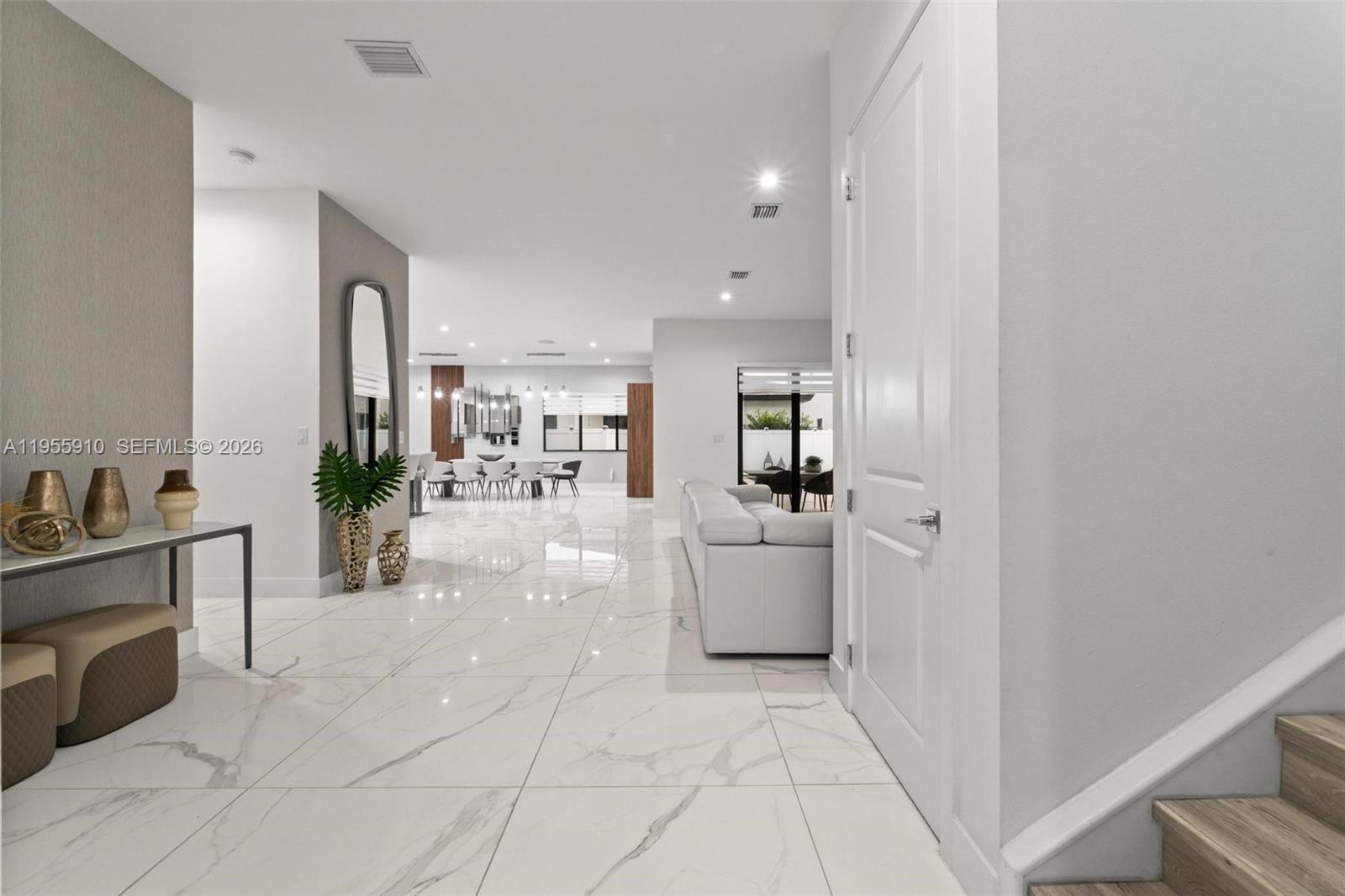 A bright, open-concept interior features white marble-look tile flooring and a modern living area — 8086 NW 47th Ter, Doral FL 33166, DORAL, FL