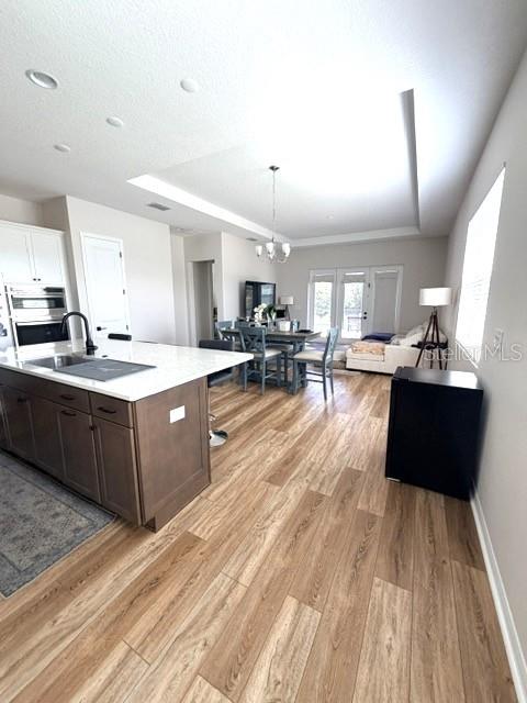 A kitchen with a large island and dining area opens into a living room space — 1647 KEY BAY TRAIL, KISSIMMEE, FL