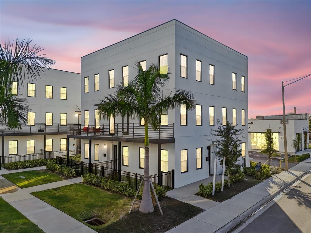 A three-story modern apartment building with white exterior walls, black window frames, and palm trees — 2724 5TH AVENUE S, ST PETERSBURG, FL