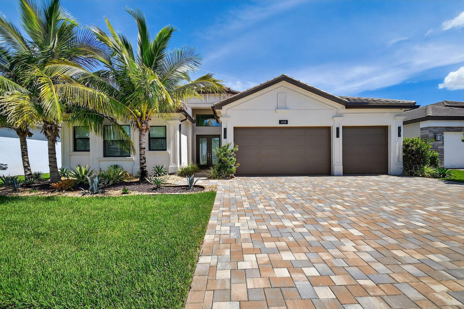 A single-story house features a paved driveway, a three-car garage, and palm trees — 11158 Glen Orchard Lane, Boynton Beach FL 33473, BOYNTON BEACH, FL