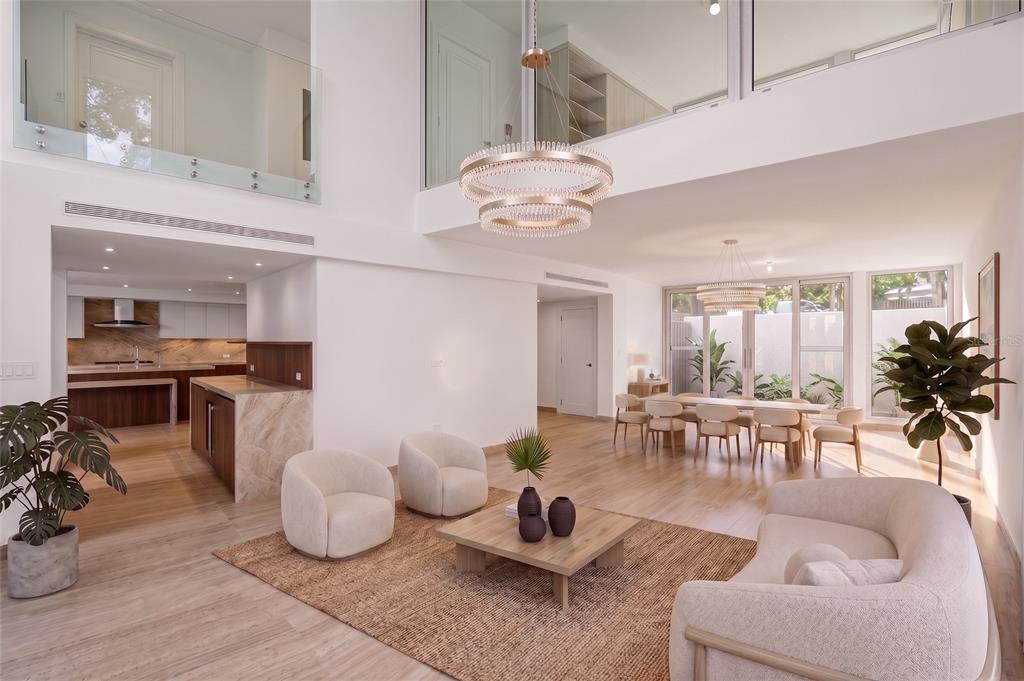 A spacious, modern open-concept living area with high ceilings, neutral furniture, and a kitchen — 2111-2112 VILLA DORADO BEACH ESTATES, DORADO, PR