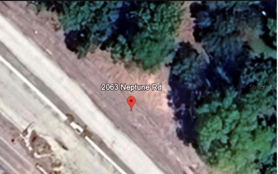 An aerial map view shows a plot of land located next to a road — 2063 NEPTUNE ROAD, KISSIMMEE, FL