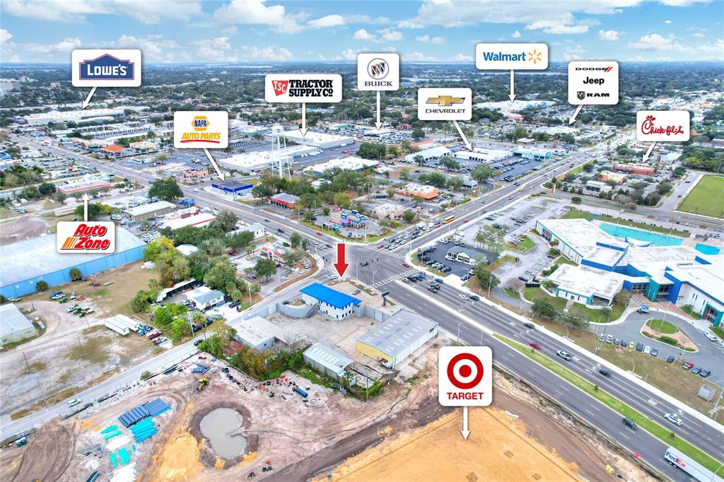 This aerial view shows a commercial area with various retail stores and a construction site — 1803 3RD STREET SW, WINTER HAVEN, FL