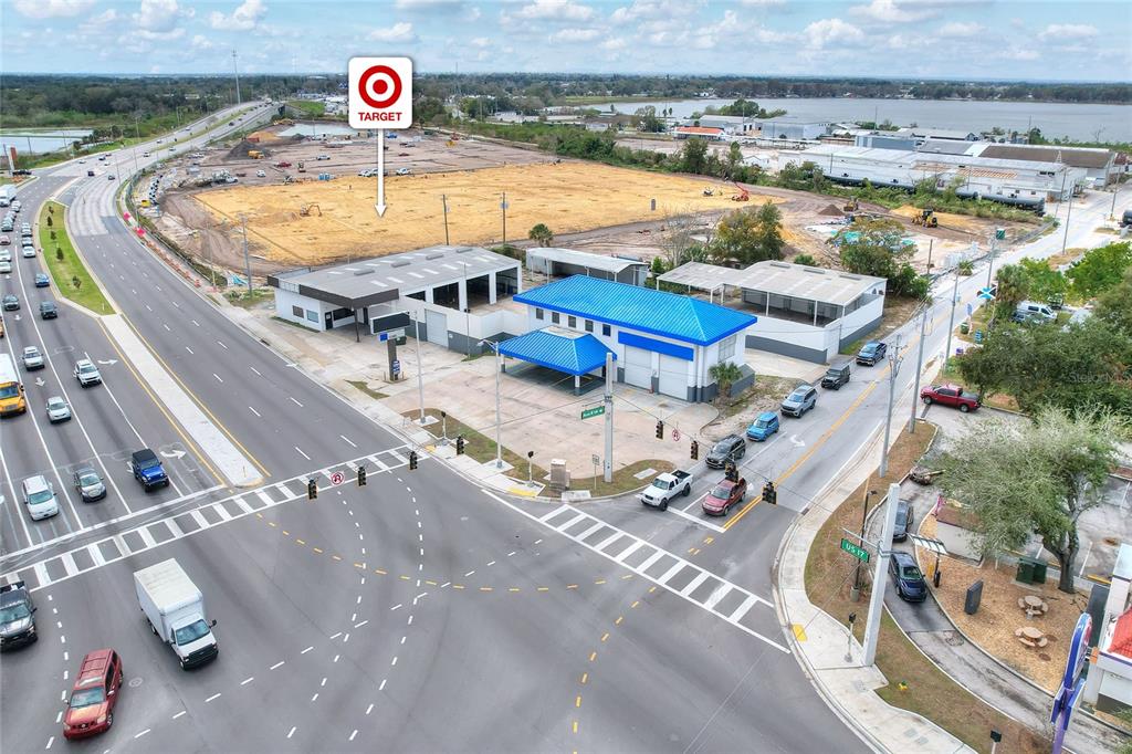 An aerial view shows a commercial building with a blue roof at a road intersection — 1803 3RD STREET SW, WINTER HAVEN, FL