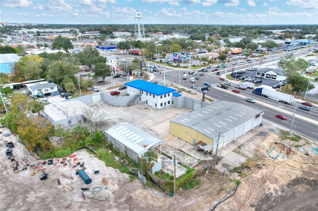 An aerial view shows a commercial property with multiple industrial buildings and a paved lot — 1803 3RD STREET SW, WINTER HAVEN, FL