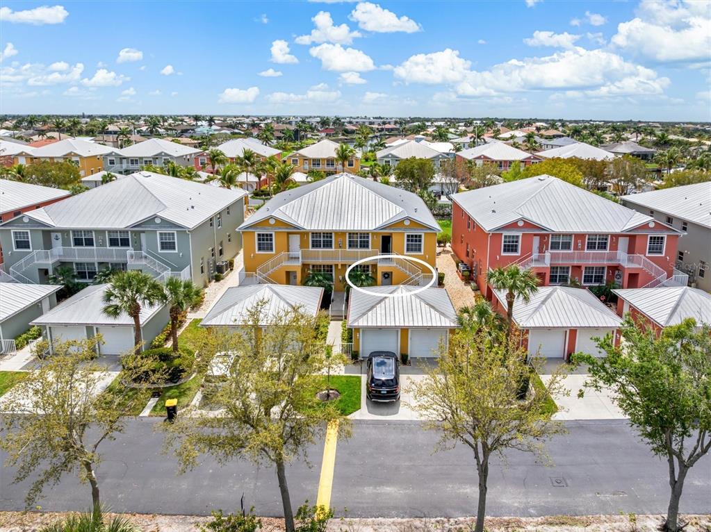 An aerial view shows a yellow two-story residential building with a circled front entrance — 2002 BAL HARBOR BOULEVARD UNIT 312, PUNTA GORDA, FL