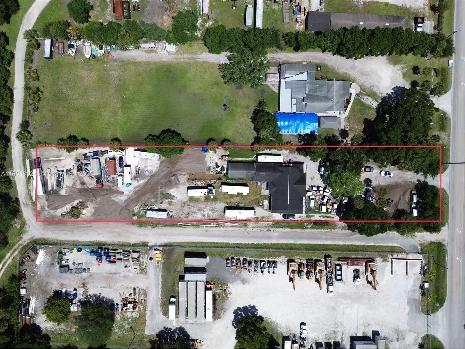 An aerial view shows a rectangular property containing several buildings, trailers, and vehicles — 603 S 33rd St, Fort Pierce FL 34947, FORT PIERCE, FL