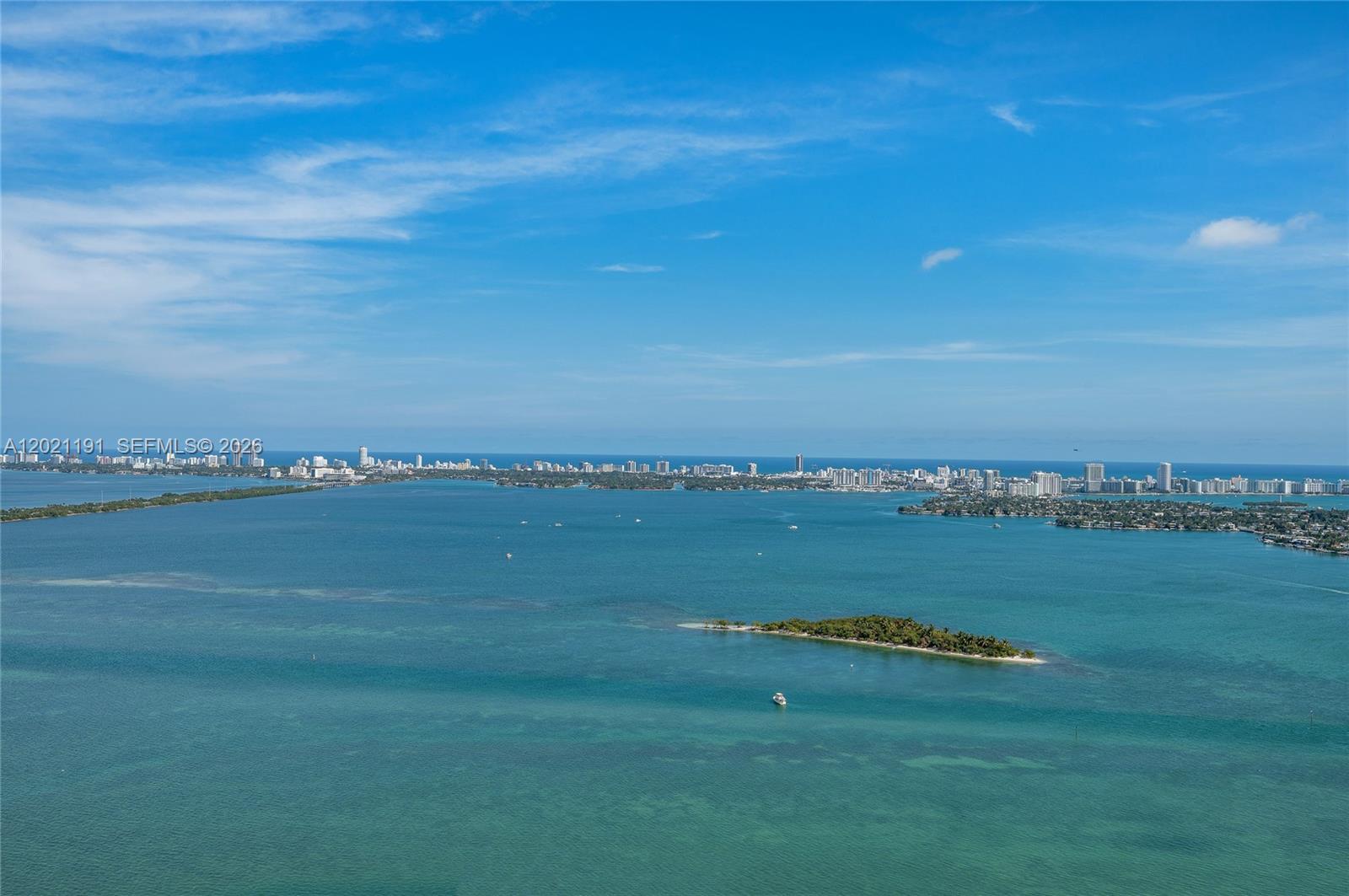 An aerial view shows a small island in a bay with a distant city skyline — 700 NE 24th Street, Miami FL 33137, MIAMI, FL