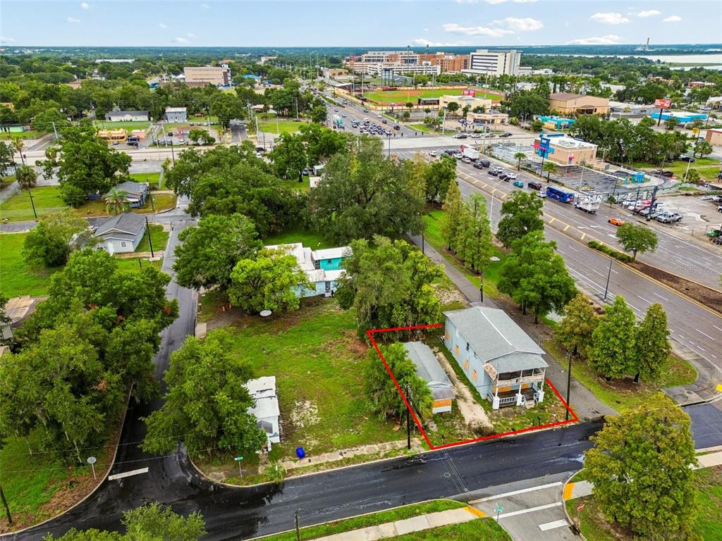 An aerial view shows a residential property outlined in red, featuring two buildings and trees — 115 EMMA STREET, LAKELAND, FL