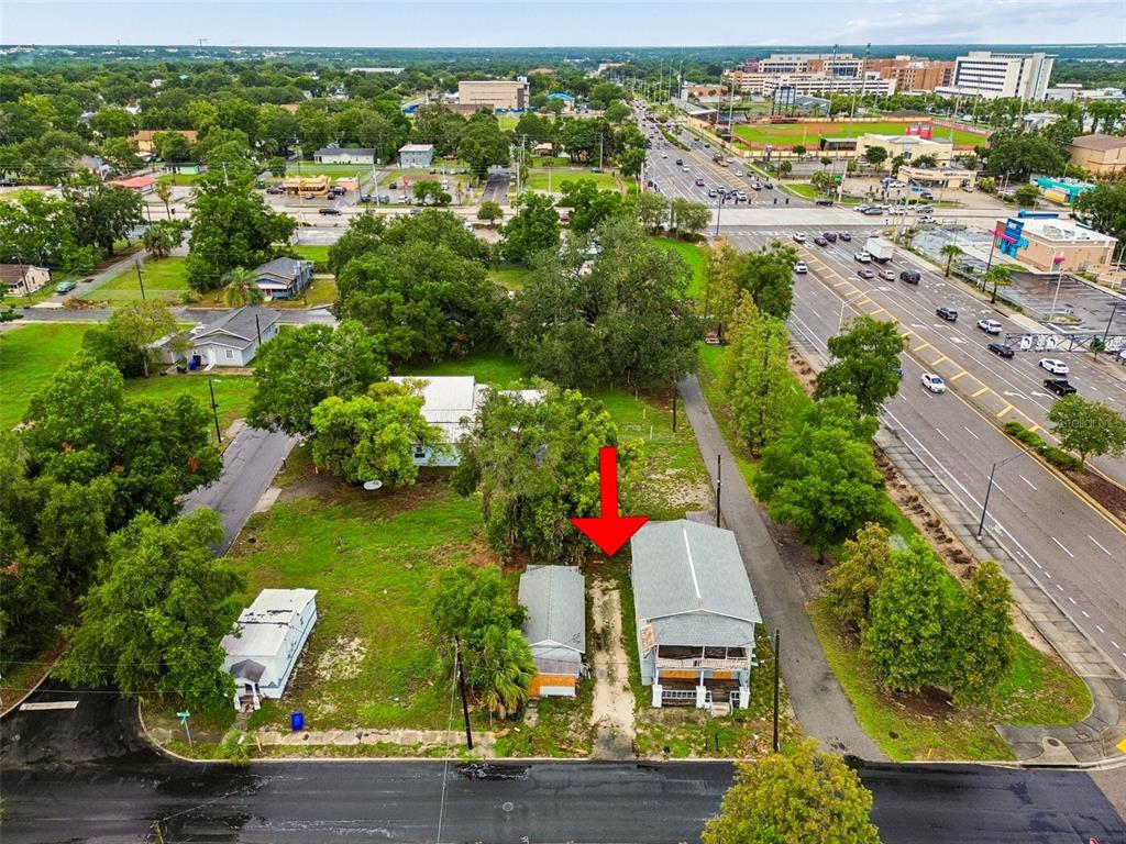 An aerial view shows two small buildings on a lot next to a busy road — 115 EMMA STREET, LAKELAND, FL