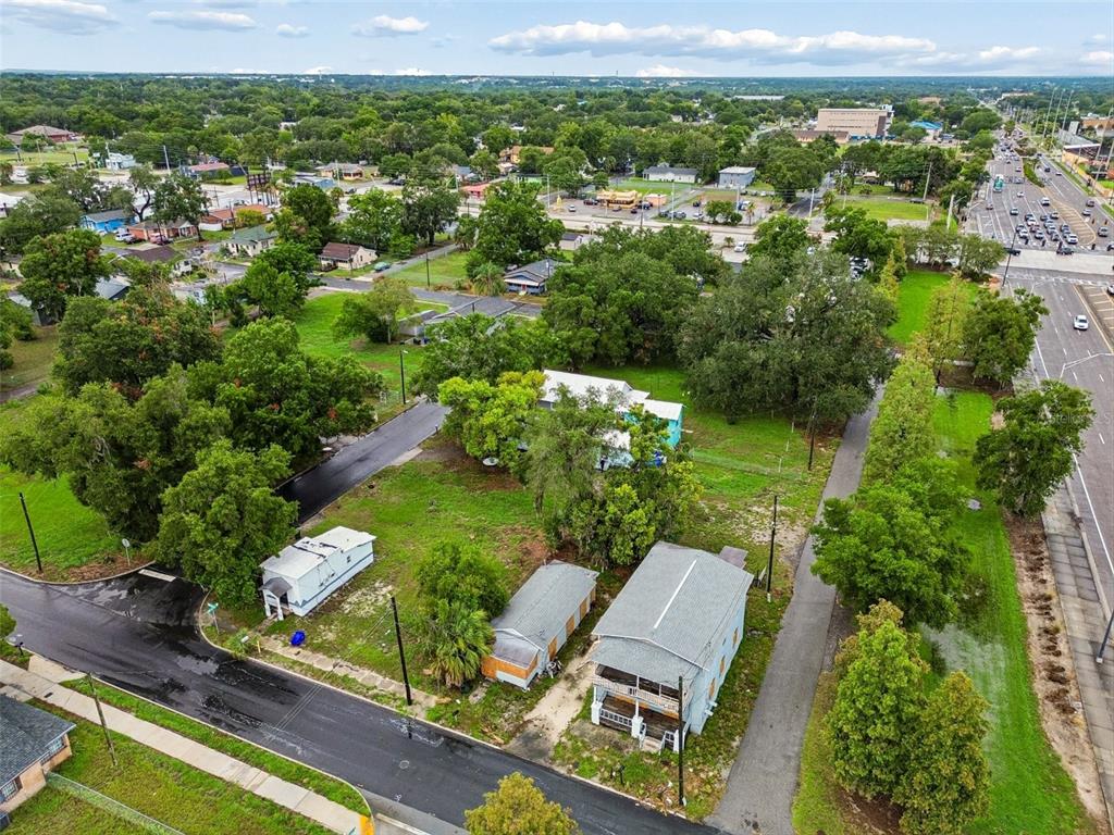 An aerial view shows several small houses and a trailer on a grassy lot — 115 EMMA STREET, LAKELAND, FL