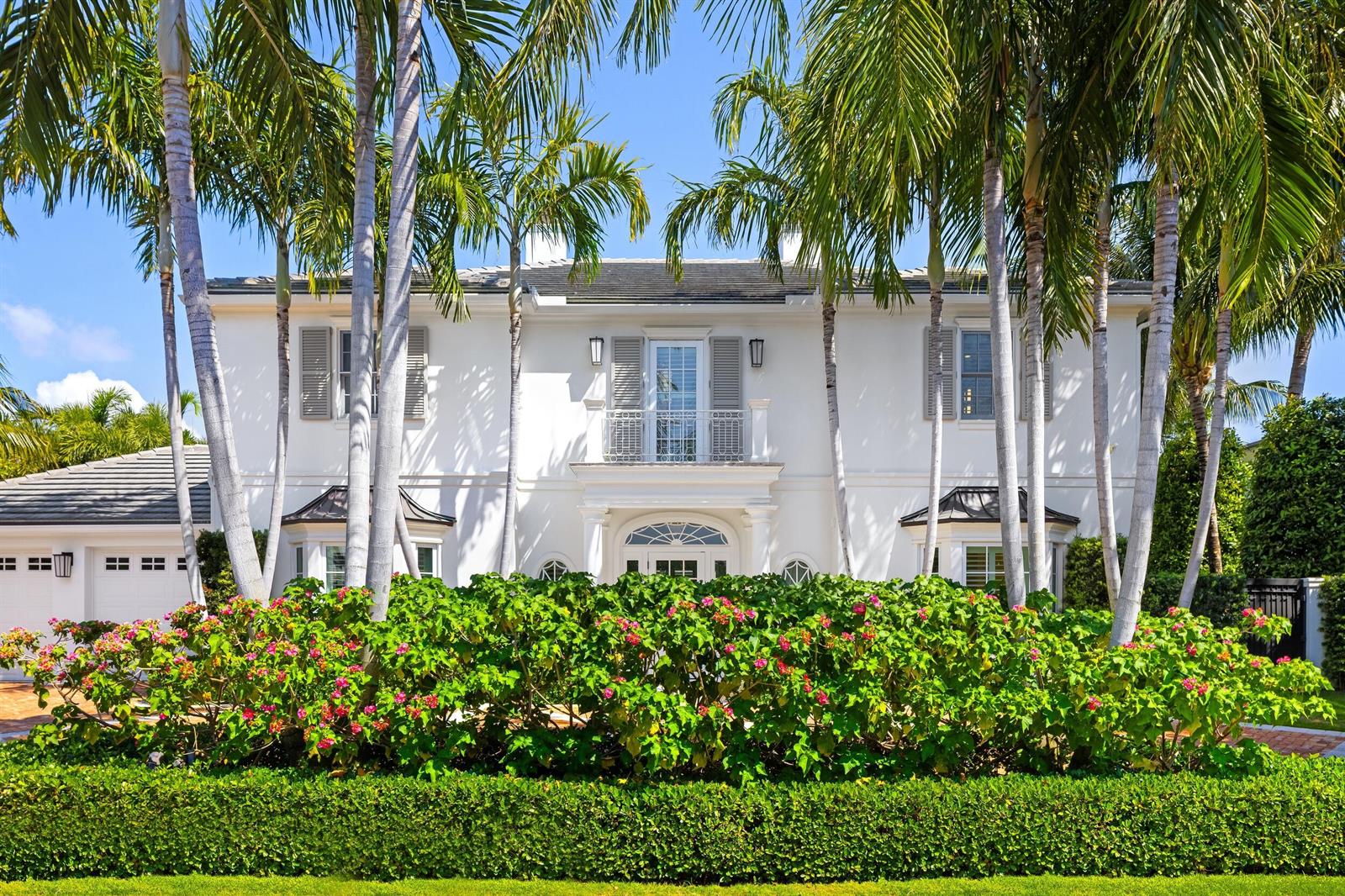 A two-story white house with a balcony, palm trees, and a flowering hedge in front — 211 Ocean Terrace, Palm Beach FL 33480, PALM BEACH, FL