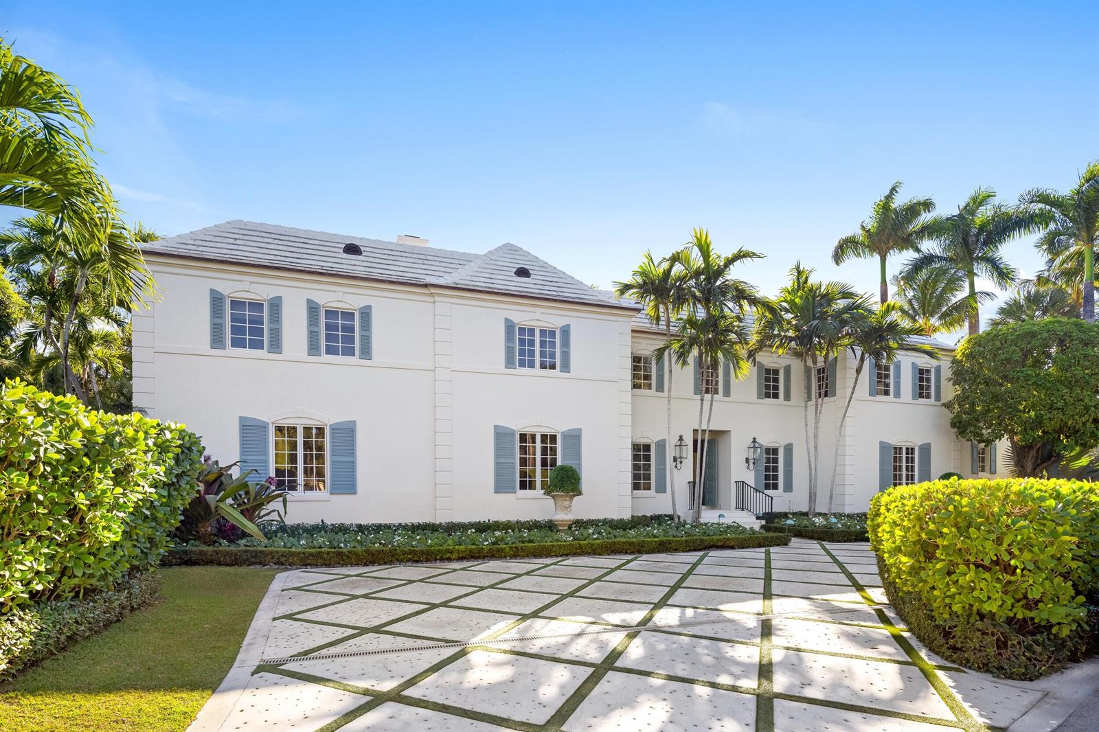 A two-story white house with blue shutters and a grid-patterned driveway surrounded by palm trees — 9 Via Vizcaya, Palm Beach FL 33480, PALM BEACH, FL