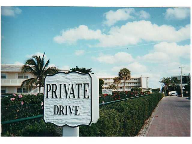 A sign reading Private Drive stands in front of a multi-story apartment building and landscaping — 50 Celestial Way # 8e, Juno Beach FL 33408, JUNO BEACH, FL