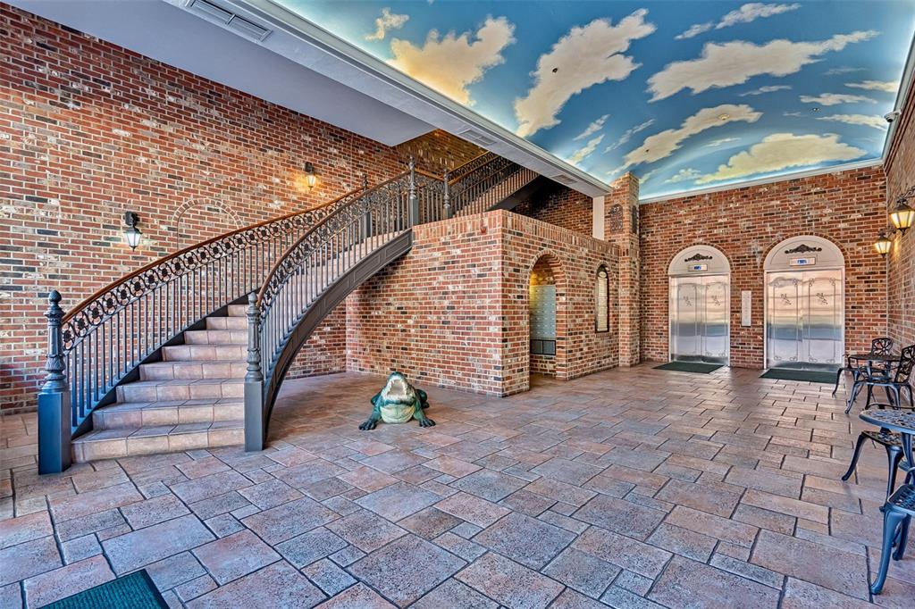 An indoor lobby features a brick staircase, a painted sky ceiling, and an alligator statue — 201 SE 2ND AVENUE UNIT 317, GAINESVILLE, FL