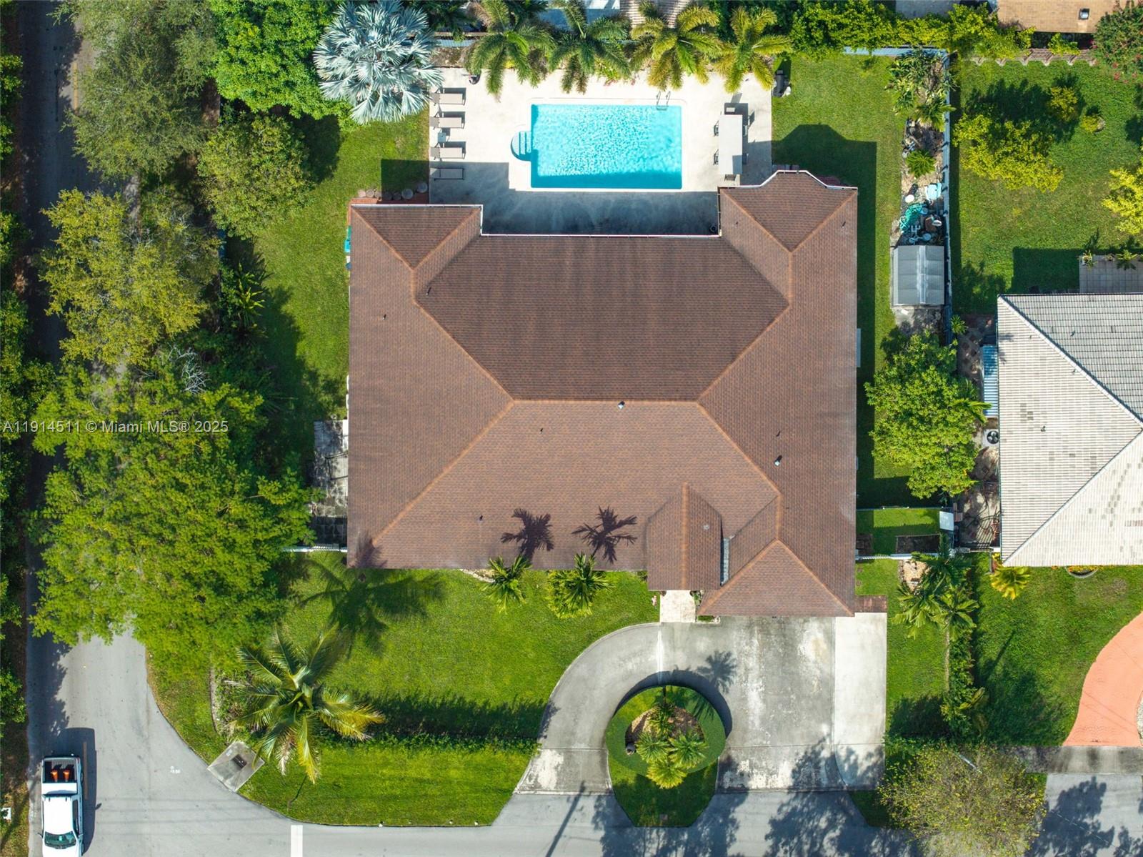 An aerial view shows a house with a brown roof, a pool, and a circular driveway — 10195 NW 26th St, Doral FL 33172, DORAL, FL
