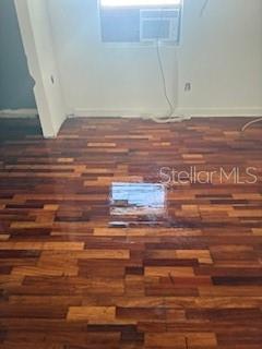 A room with dark wood-look flooring and a window air conditioning unit — 2405 E 17TH AVENUE, TAMPA, FL