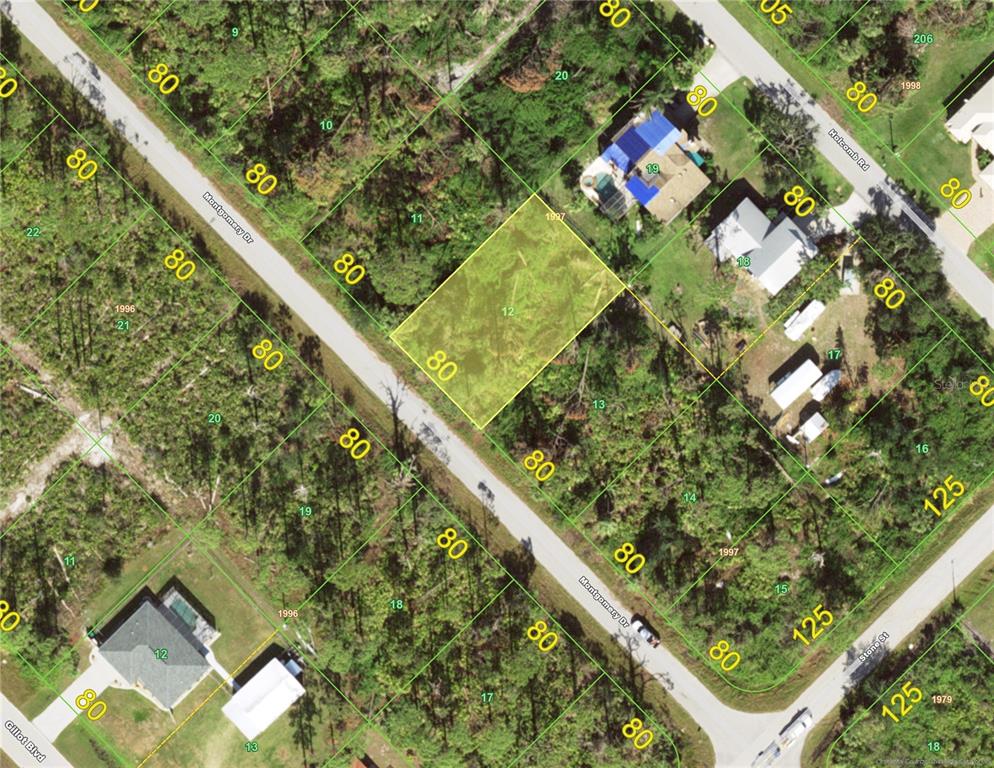 This is an aerial map showing a highlighted vacant lot surrounded by wooded residential properties — 3116 MONTGOMERY DRIVE, PORT CHARLOTTE, FL
