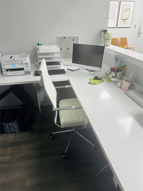 A white L-shaped desk with a computer and office chair sits in a modern office — 4106 W LAKE MARY BOULEVARD UNIT 205, LAKE MARY, FL