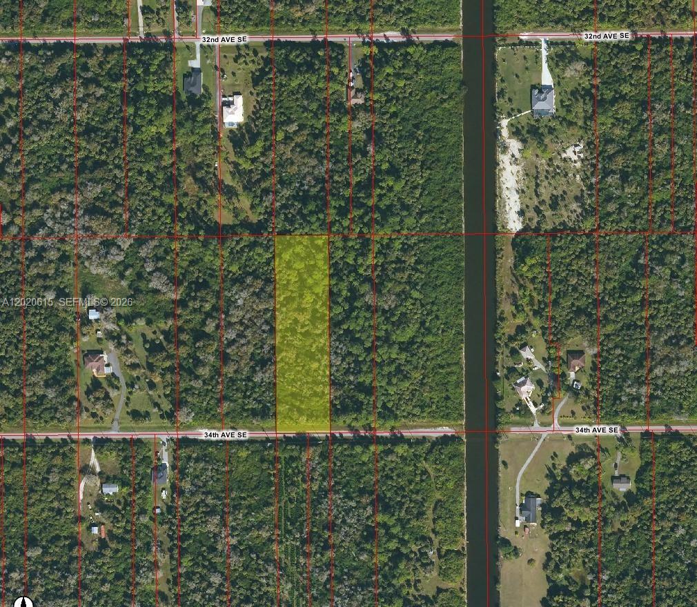 An aerial map shows a rectangular, highlighted vacant lot situated between two residential streets — 3811 SE 34 Ave, Naples FL 34117, NAPLES, FL