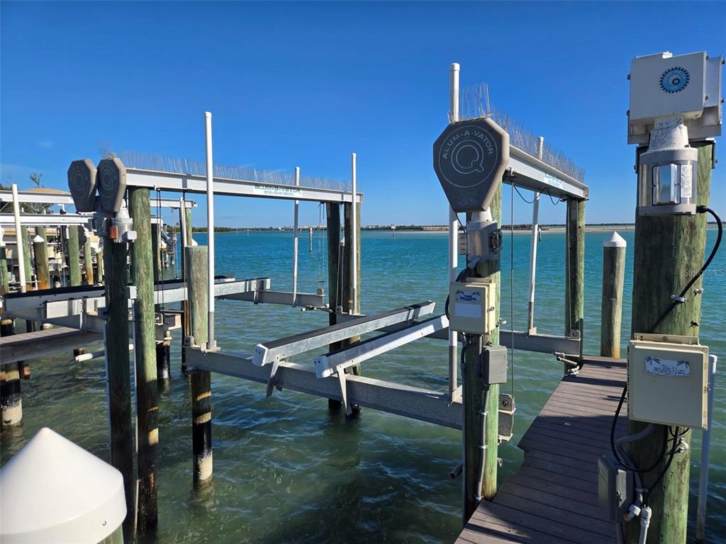 A boat lift structure stands over turquoise water at a wooden dock — 6040 BOCA GRANDE CAUSEWAY UNIT 11 Boat Slip, BOCA GRANDE, FL