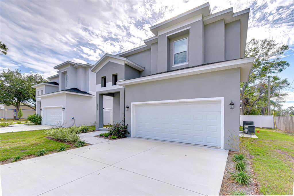 A two-story gray house with a two-car garage and a concrete driveway — 5312 76TH AVENUE N, PINELLAS PARK, FL