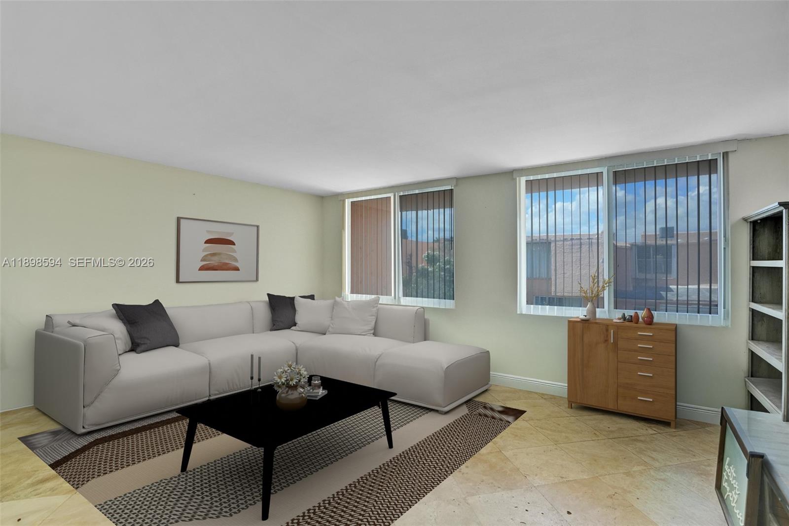 A living room features a white sectional sofa, a black coffee table, and tile flooring — 4350 W 11th Ct # 62, Hialeah FL 33012, HIALEAH, FL